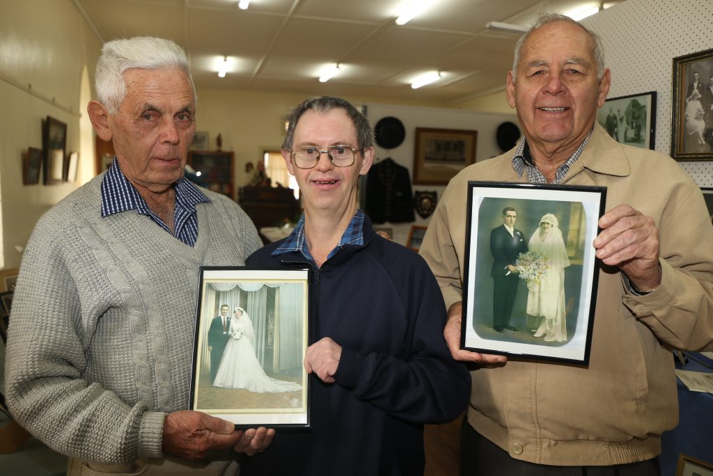 Kev, David and Bernard Stephens with their families wedding photos on display in the museum.
